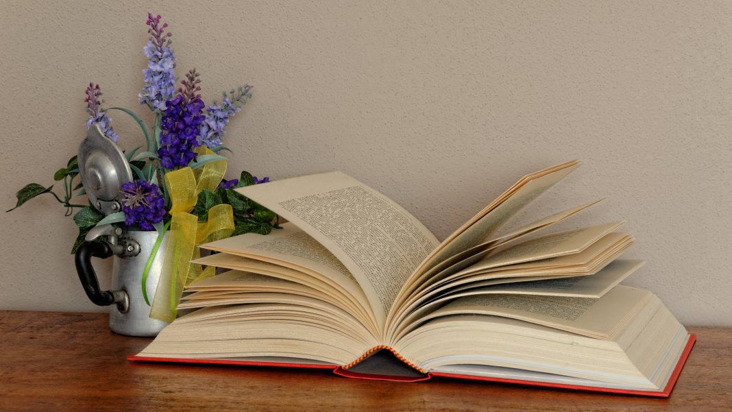 open-book-with-purple-flowers-in-vase-still-life-2026-01-09-13-12-07-utc